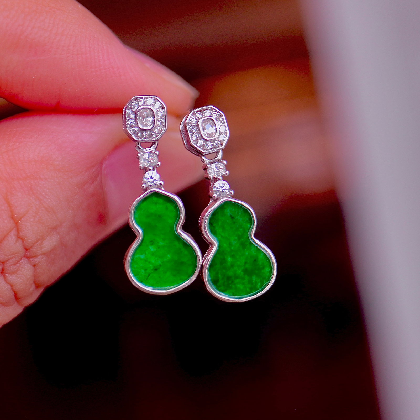 Natural Jadeite Earrings: Title: Natural Jadeite Earrings Description: These earrings feature natural jadeite carved into a gourd shape, showcasing the full green color of the jadeite. Set in S925 sterling silver, the overall 