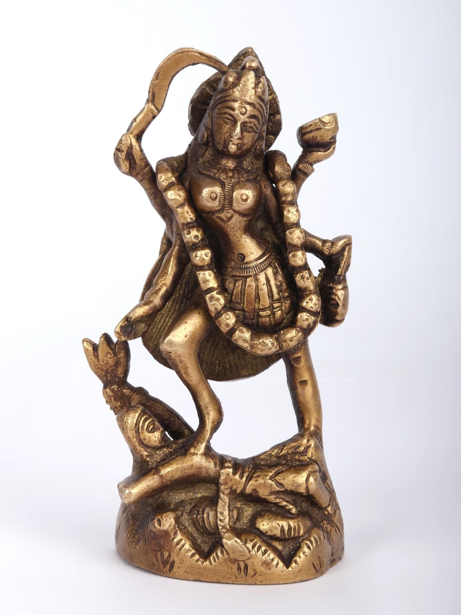 4" Small Mother Kali Statue In Brass | Handmade | Made In India: Description: See It In Your Home In this striking brass statue, Mother Kali stands tall, her fierce visage reflecting both destruction and creation. She holds symbols of power, compassion, and protect