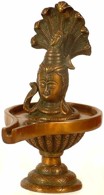 10" Shiva Linga Brass Idol | Handcrafted Indian Religious Statue: Description: In this ten inch tall fine brass Shiva-linga the 'Linga' motif has been replaced by a Shiva-head. It is a common phenomenon of Shiva iconography that the 'Linga' and His human form, His
