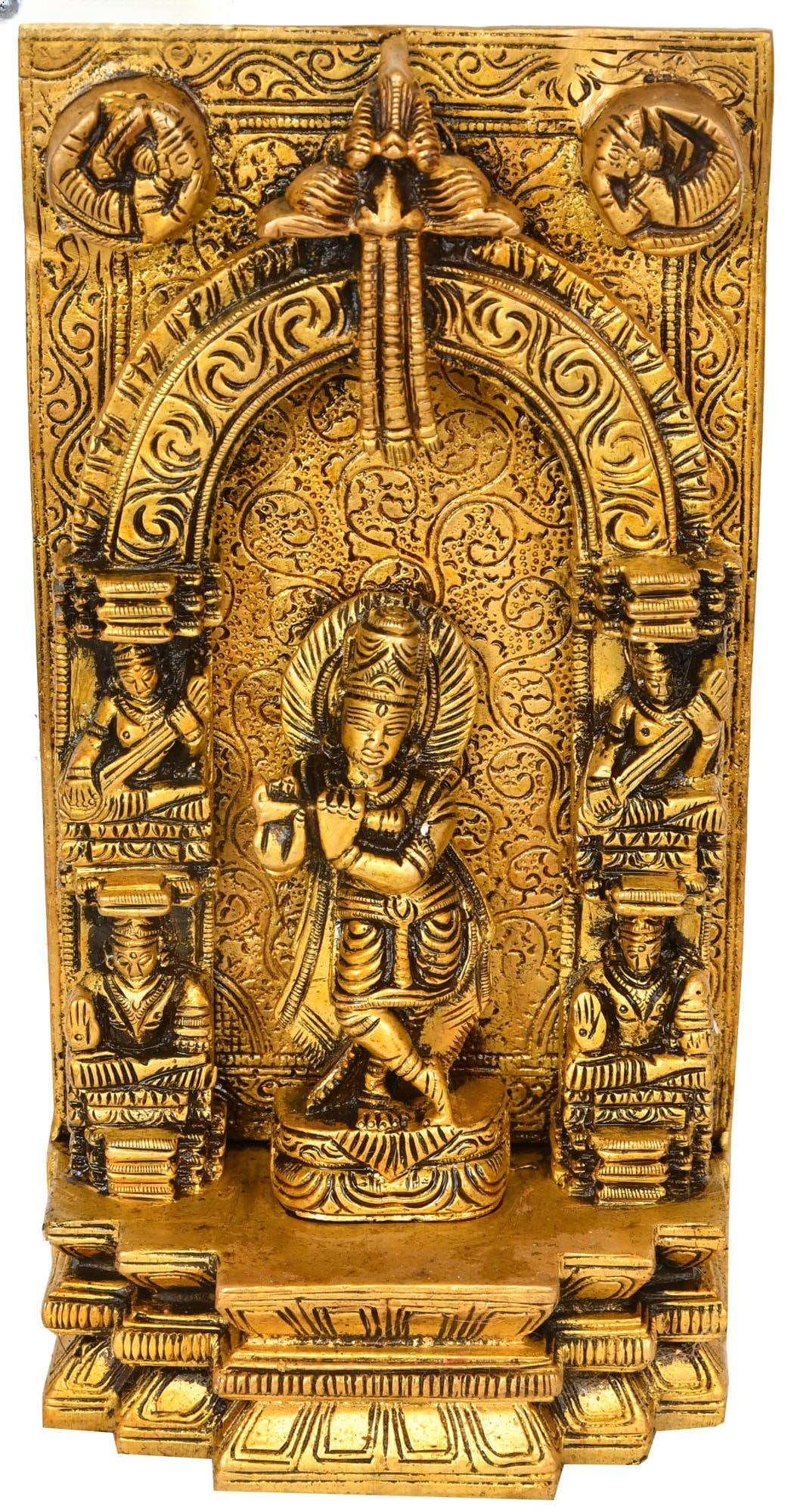 7" Brass Fluting Krishna Idol on Almond-Shaped Aureole | Handmade Religious Figurine: Description: Shri Krishna is the 19th full incarnation of Sakshat Purushottam. When Krishna is depicted as being the age below10, it is always with his flute. Therefore, he is aptly called