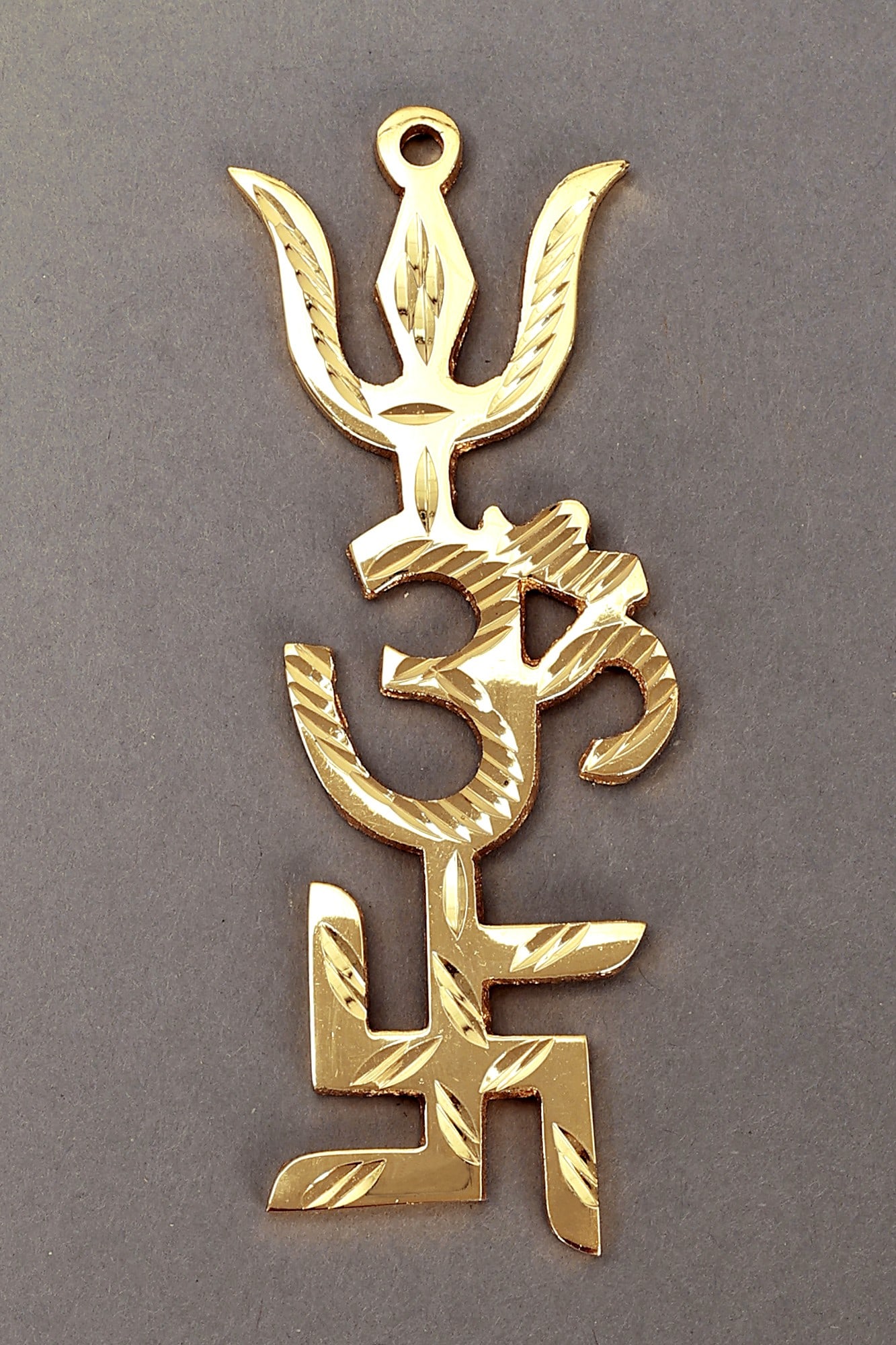 Tri Shakti Pooja Yantra | Swastik Om Trishul Symbol: Description: See It In Your Home Yantras are means of removing malevolent energy and attracting fortunate energies into a location. This Tri Shakti Pooja Yantra is one such way or artifact that can ai