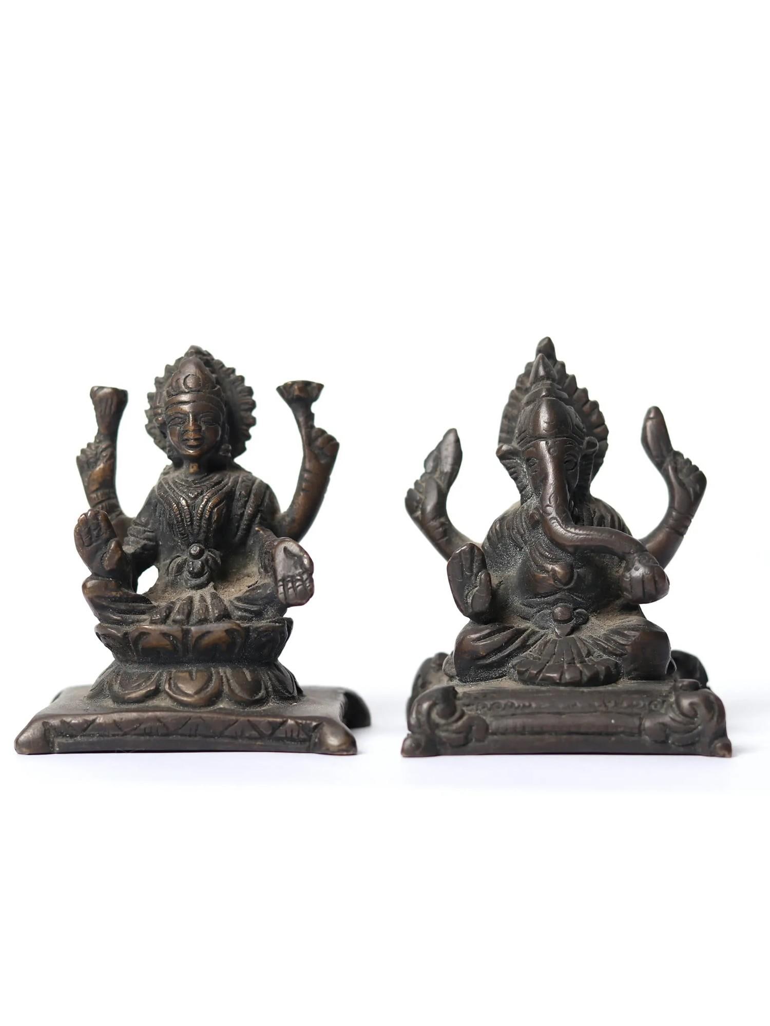 3" Small Blessing Lakshmi Ganesha Brass Statue: Description: In the radiance of brass, this divine masterpiece emerges. Here, “ Lord Ganesha ”, the harbinger of wisdom and auspicious beginnings, graces the scene. His right hand extends in