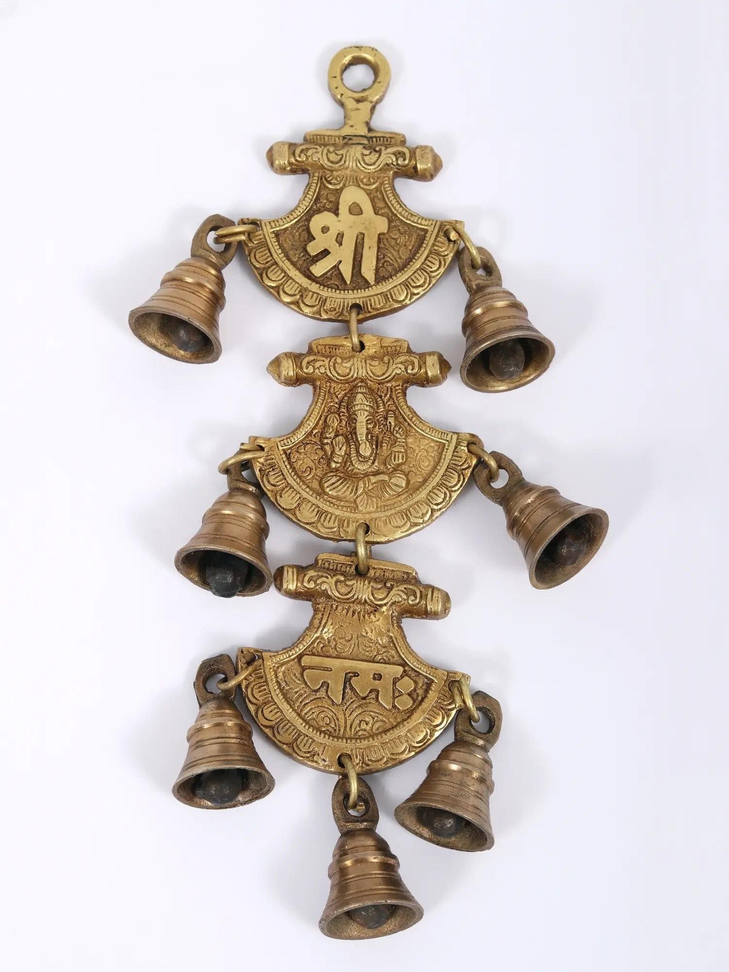 11" Shri Ganeshay Namah Hanging Bell in Brass: Description: This lovely wall-hanging bell is crafted of high-quality brass and has the sacred mantra "Shri Ganeshaye Namah" in the shape of three separate sections connected together. The first