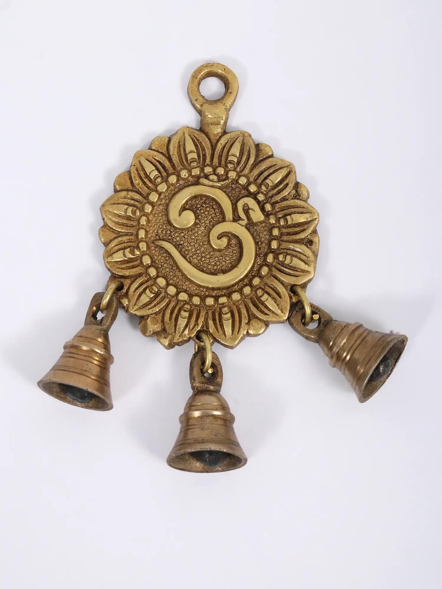 7" Om Hanging Bell in Brass: Description: This Om hanging bell is a mystical manifestation of devotion and Indian workmanship. It is handcrafted in India and includes the Om sign, which represents heavenly energy and hangs