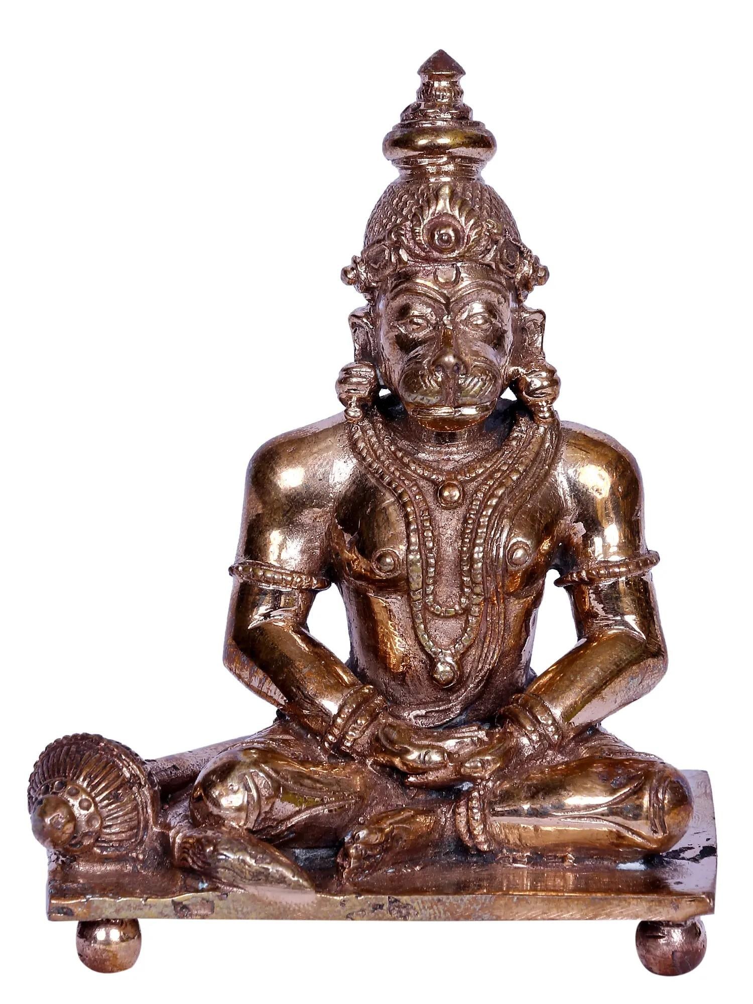 3" Sitting Sankat Mochan Hanuman Bronze Sculpture: Description: In this divine tableau frozen in bronze, Lord Hanuman , “also known as Maruti”, “ the beloved son of the wind god Vayu”, assumes a profound stillness in the “ Dhyana
