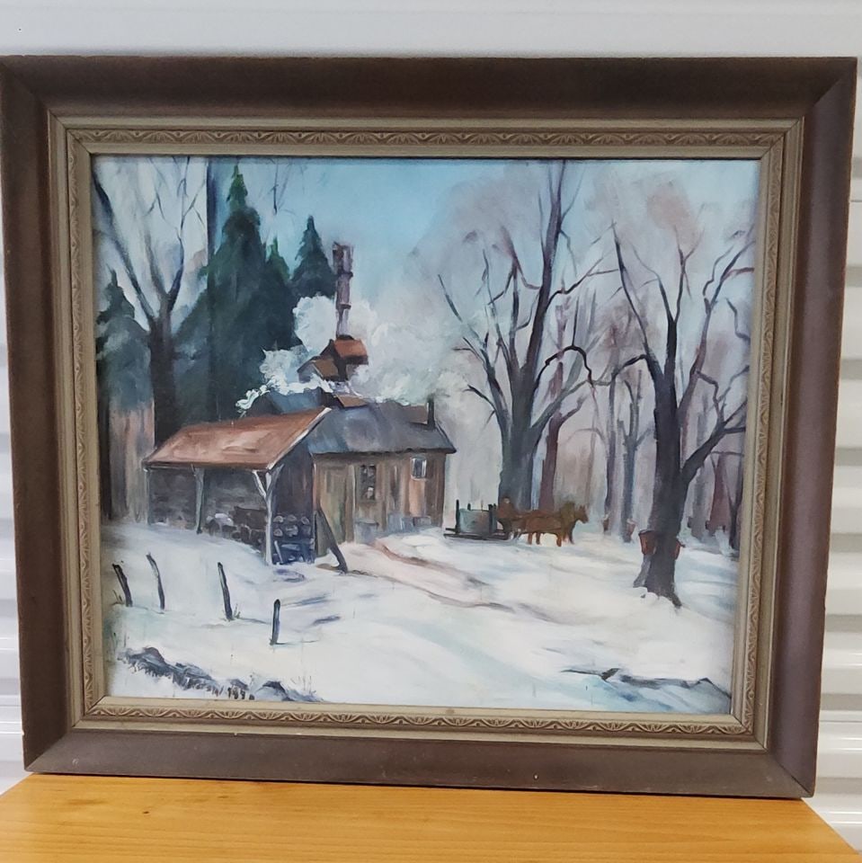 Captivating mid-century impressionist oil painting of snow covered country landscape. Signed.1970s: A wonderful example of minimalism employed in an impressionist work. Original signed painting of a winter cabin scene, featuring a cabin with a rusty roof and chimney, surrounded by snow-covered trees