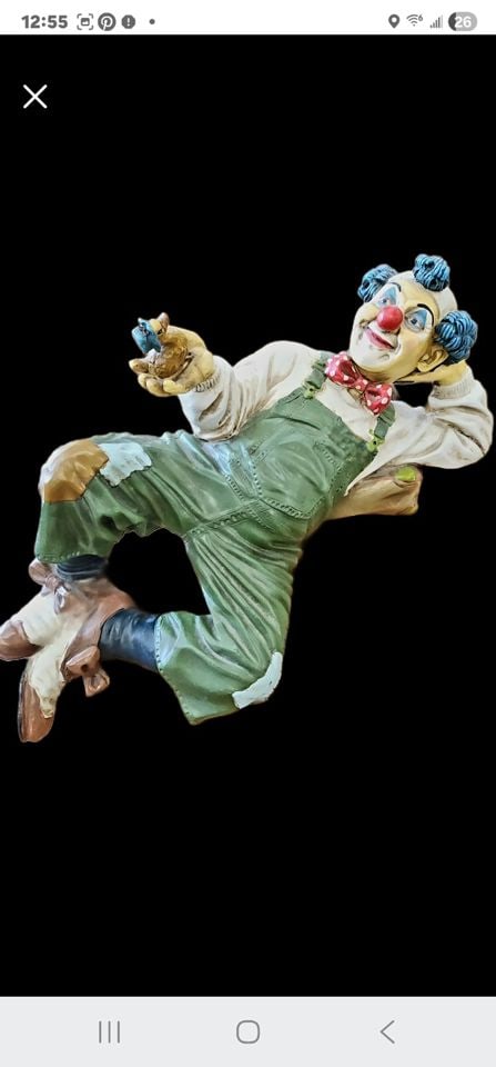 Collectible Vintage Clown Sculpture Attributed to Jun Asilo Hand-Painted on Resin Composite. C.1980s: This is a 18in vintage reclining clown statue holding a duck likely created by78h the prominent Filipino artist Jun Asilo who is known for his highly expressive, large-scale clown figurines). The scul