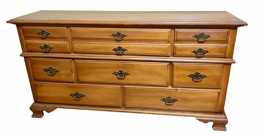 Vintage Style Wood Dresser with Brass Hardware: This is a vintage style wood dresser featuring a warm wood finish and ornate brass-tone pull handles. The dresser has a total of eight drawers, with two small drawers and two medium drawers on the