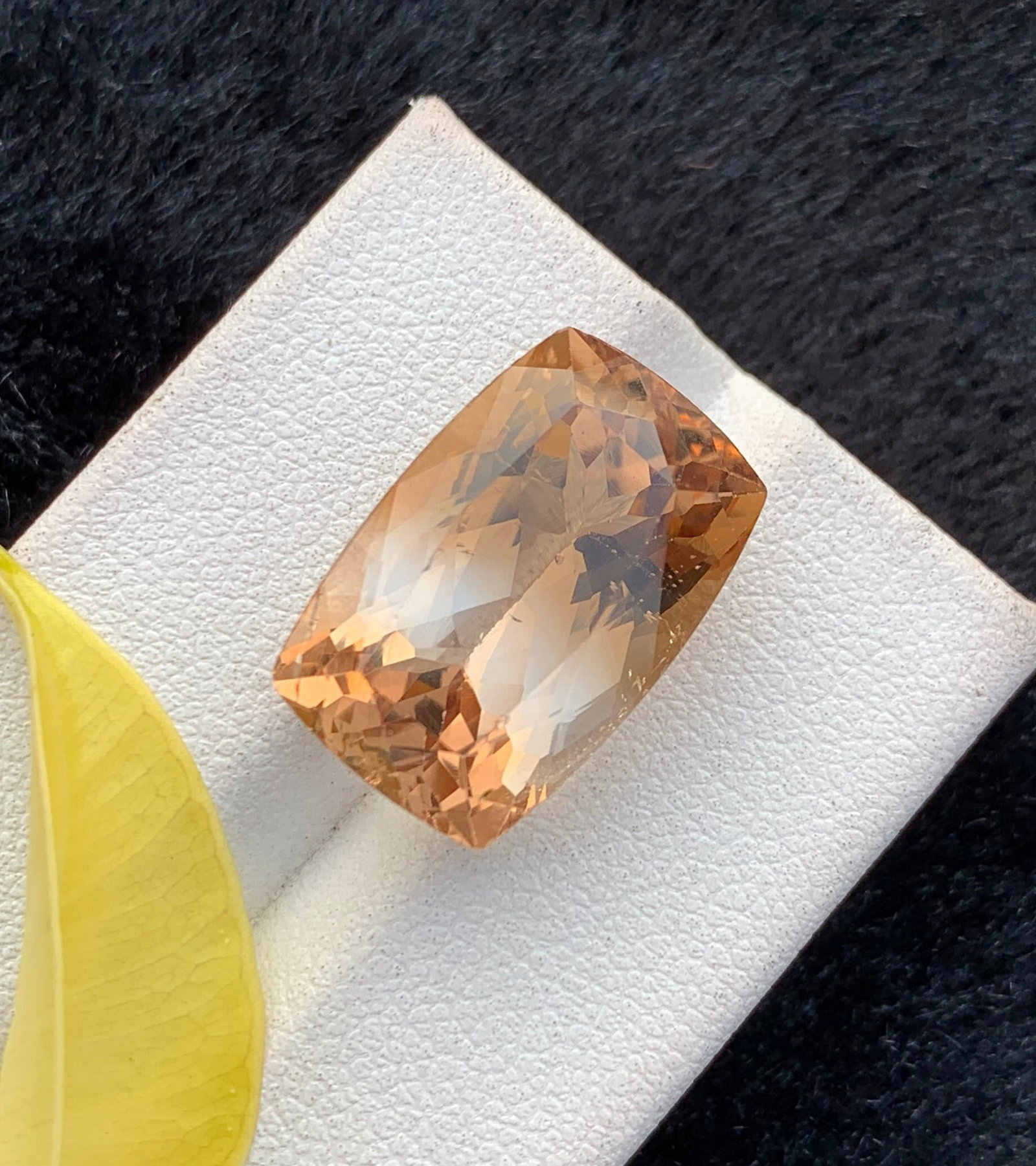 Peach Orange Topaz Gemstone: 20 Carat Long Cushion Cut: Discover the allure of our Peach Orange Topaz Loose Gemstone, boasting a mesmerizing sparkle in a delightful peach-orange hue. Skillfully faceted into a captivating trillion cut, this fine gem is perf