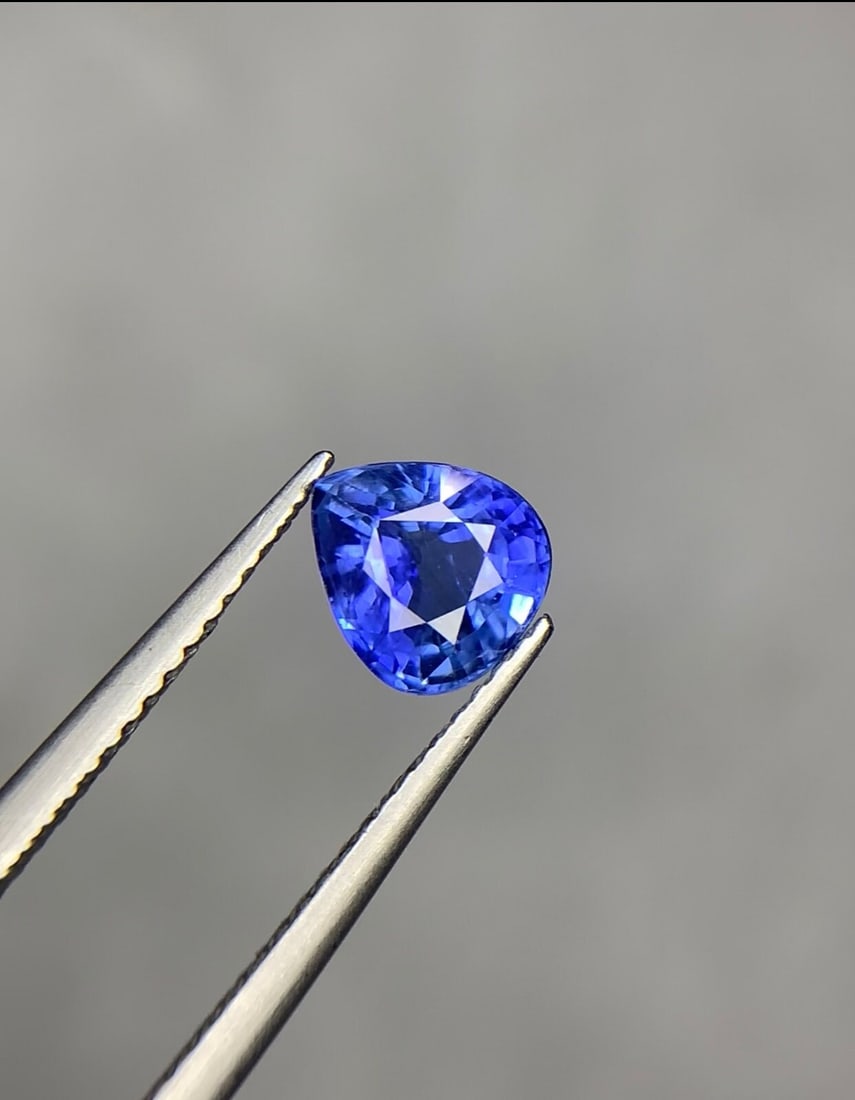Ceylon Blue Sapphire Gemstone: 1.50 Ct Pear Cut, Heated: This stunning sapphire weighs 1.50 carats and features a captivating Deep blue color. It is expertly cut into a Perfect Pear shape, adding to its elegance and it possesses a well-proportioned and
