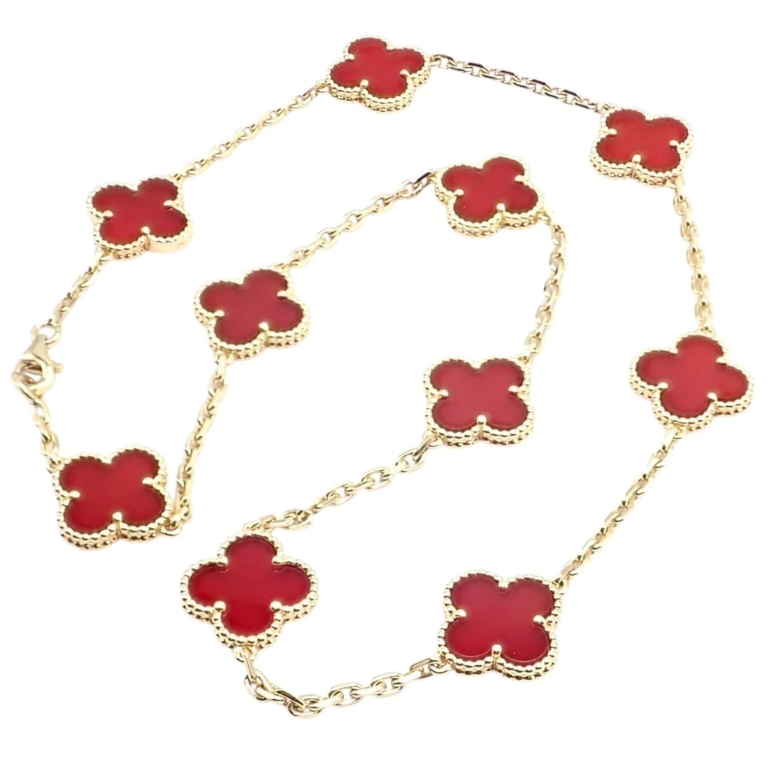 Authentic Van Cleef & Arpels 18k Gold 10 Motif Alhambra Carnelian Necklace Paper: Van Cleef & Arpels Alhambra necklace crafted in 18k yellow gold with ten vibrant carnelian motifs framed by signature beaded edges. Warm, rich red hues evoke luck and joy, while the long, elegant silh
