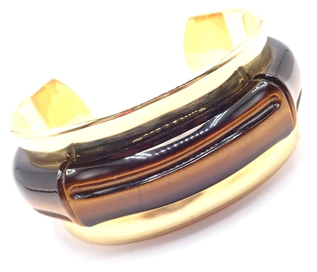 Authentic! Tiffany & Co 18k Yellow Gold Tiger Eye Bangle Cuff Wide Bracelet 2002: Authentic! Tiffany & Co 18k Yellow Gold Tiger Eye Bangle Cuff Wide Bracelet 2002 About This Piece: Metal: 18k yellow gold Length: 7" Weight: 87.4 grams Width: 1 1/4" Hallmarks: 2002 Tiffany & Co 750 H