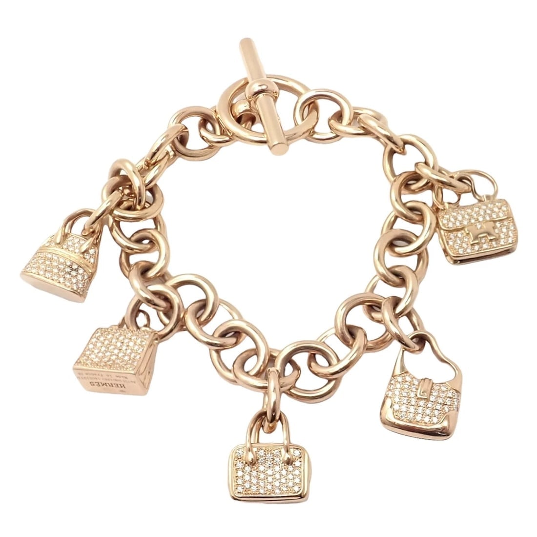 Authentic! Hermes 18k Rose Gold Diamond Signature Iconic Bag Charm Link Bracelet: Authentic! Hermes 18k Rose Gold Diamond Signature Iconic Bag Charm Link Bracelet About This Piece: The Hermes 18k Rose Gold Diamond Signature Iconic Bag Charm Link Bracelet is an exquisite piece of je