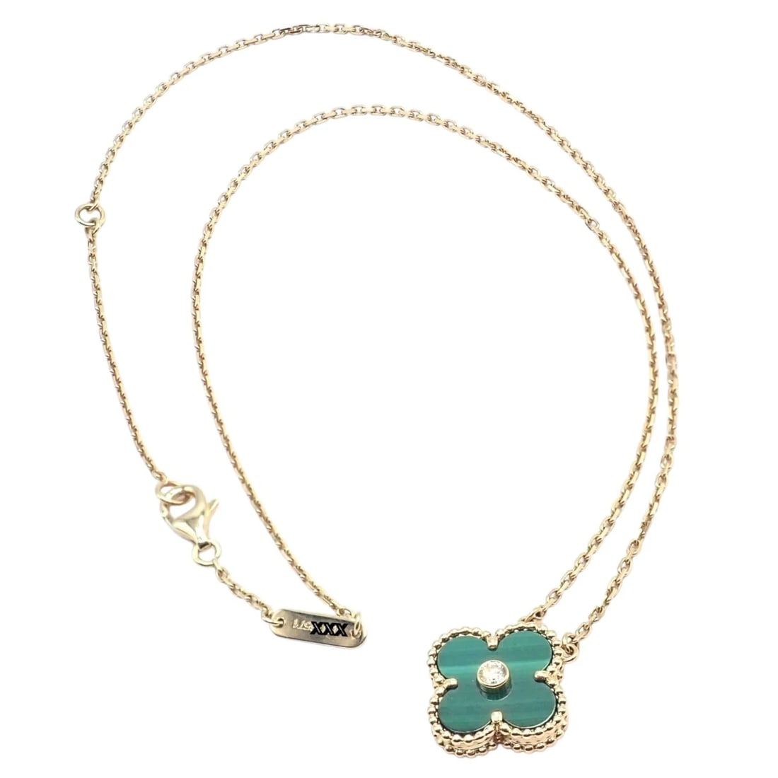 Van Cleef & Arpels Diamond 18k Vintage Alhambra Malachite Holiday 2013 Necklace: This stunning Van Cleef & Arpels Vintage Alhambra Necklace in 18k yellow gold features a delicate malachite clover motif accented with a brilliant diamond center. A limited Holiday 2013 edition, it em