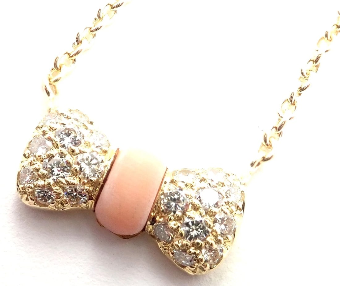 Authentic! Van Cleef & Arpels 18k Yellow Gold Diamond Coral Bow Pendant Necklace: Authentic! Van Cleef & Arpels 18k Yellow Gold Diamond Coral Bow Pendant Necklace About This Piece: Metal: 18k yellow gold Length: 15.5", Pendant: 15mm x 8mm Weight: 5.3 grams Stones: 20 diamond VVS1 c