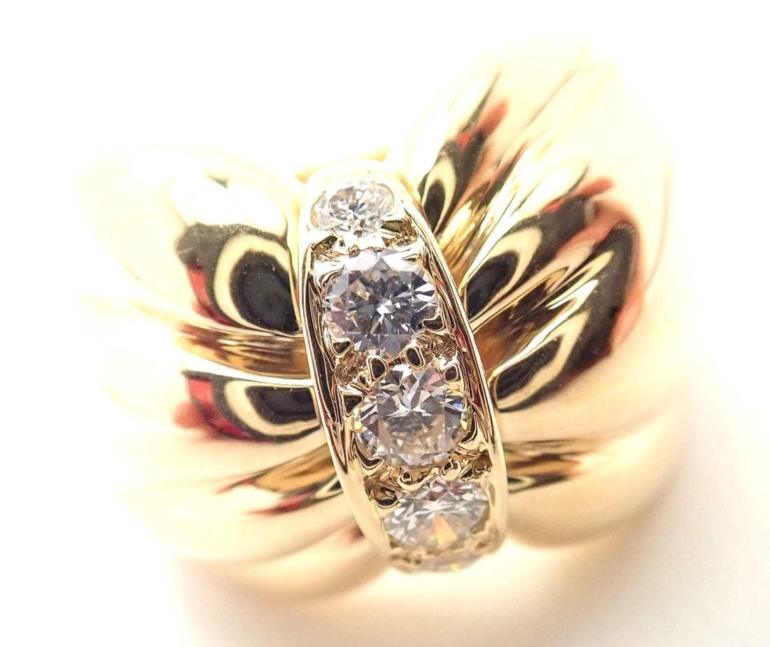 Rare! Authentic Van Cleef & Arpels 18k Yellow Gold Diamond Bow Design Band Ring: Rare! Authentic Van Cleef & Arpels 18k Yellow Gold Diamond Bow Design Band Ring About This Piece: Metal: 18k Yellow Gold Size: Measurements: 5.5 Width: 15mm Weight: 10.9 grams Stones: 5 round brillian