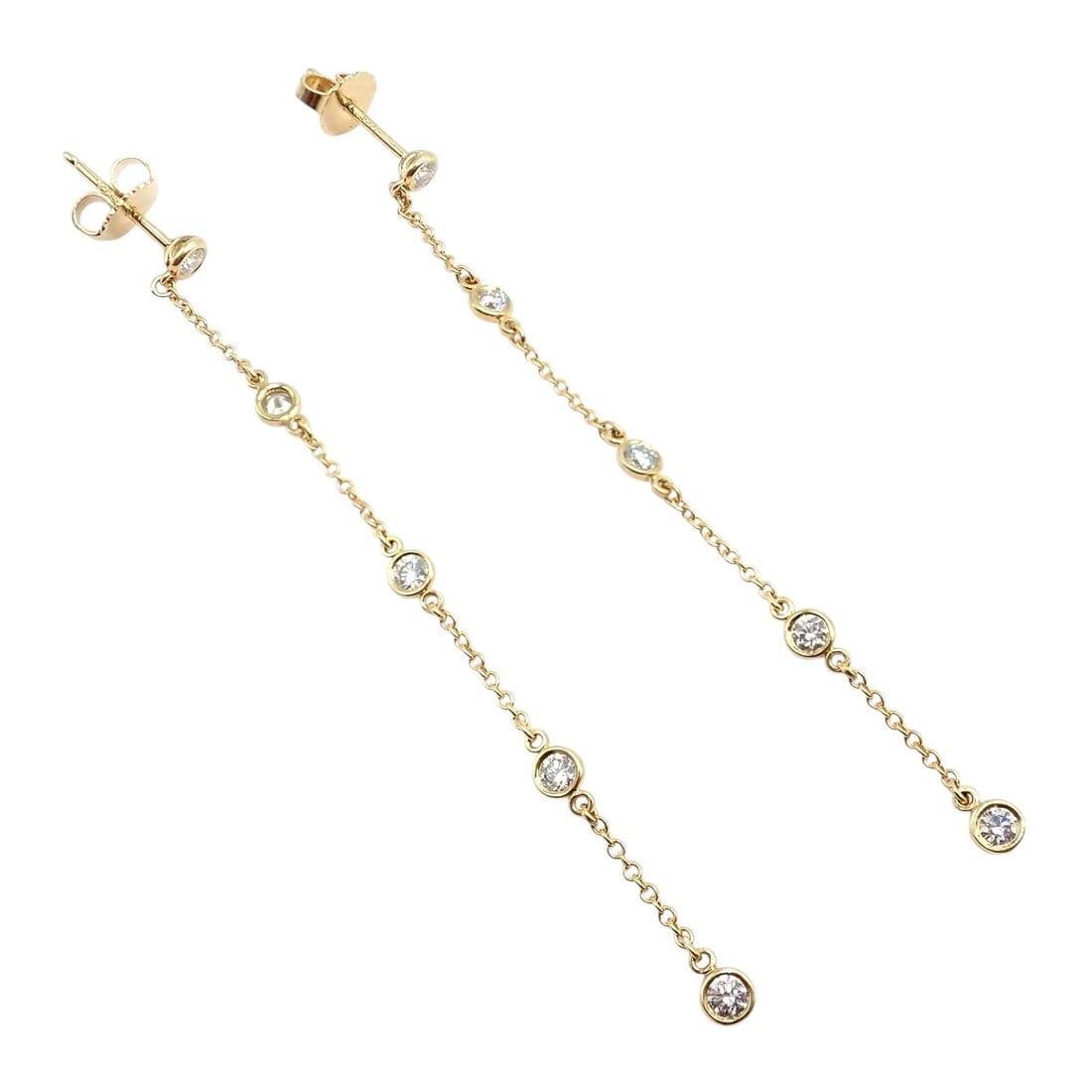 Rare! Tiffany & Co 18k Yellow Gold Peretti 10 Diamond By The Yard Drop Earrings: This rare Tiffany & Co. Elsa Peretti Diamond By The Yard drop earrings is crafted in 18k yellow gold. Each elegant chain features bezel-set round diamonds that shimmer with graceful movement. A refine