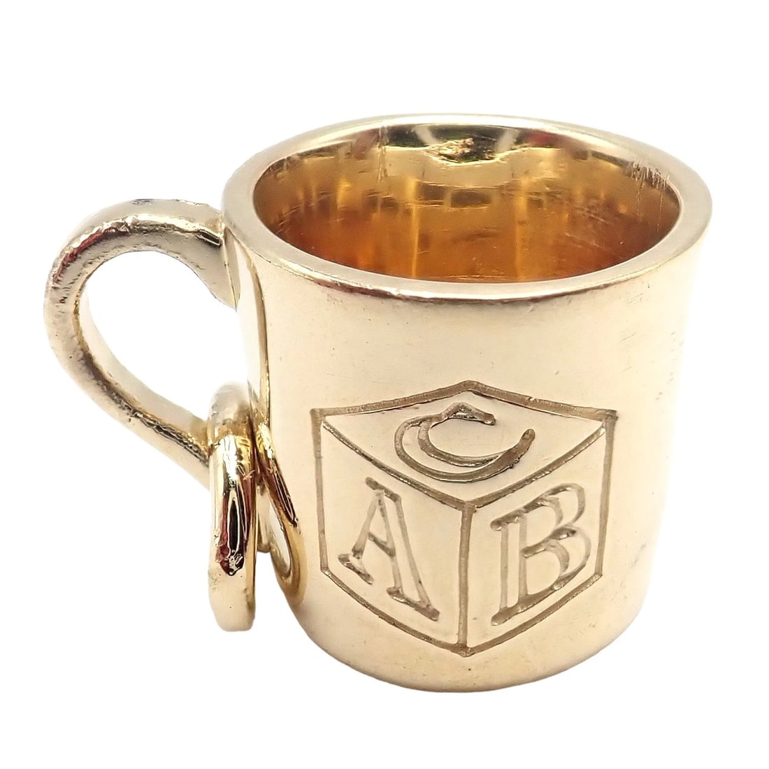 Rare Vintage Tiffany & Co. 18k Yellow Gold ABC Child Baby Cup Charm: This rare vintage charm from Tiffany & Co. is delicately crafted in 18k yellow gold, designed as an ABC child/baby cup. Its meticulous craftsmanship and playful theme embody Tiffany's commitment to qu