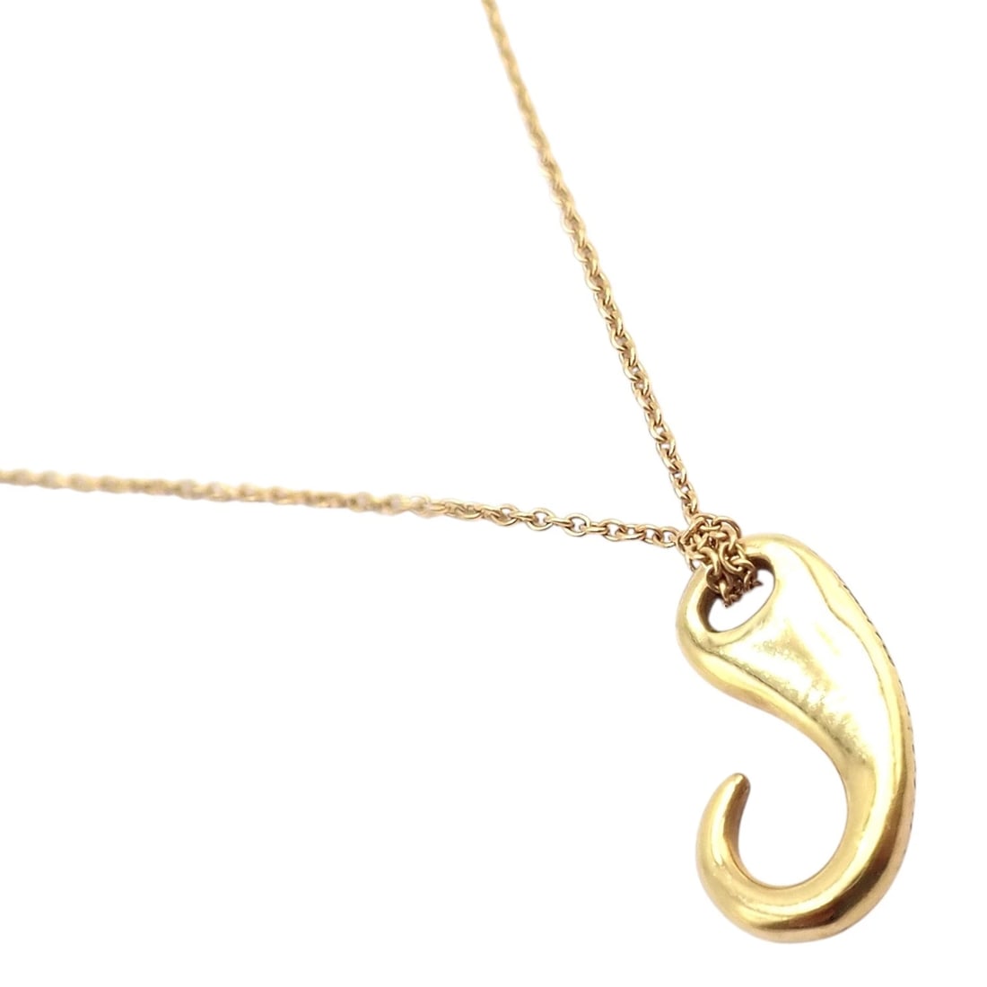 Vintage! Tiffany & Co Peretti 18k Gold Fish Hook Nautical Horn Pendant Necklace: Iconic Tiffany & Co. Elsa Peretti pendant necklace in 18k yellow gold, featuring a sculptural fish hook or horn motif. Smooth, fluid curves create a bold yet minimalist statement. Suspended from a del