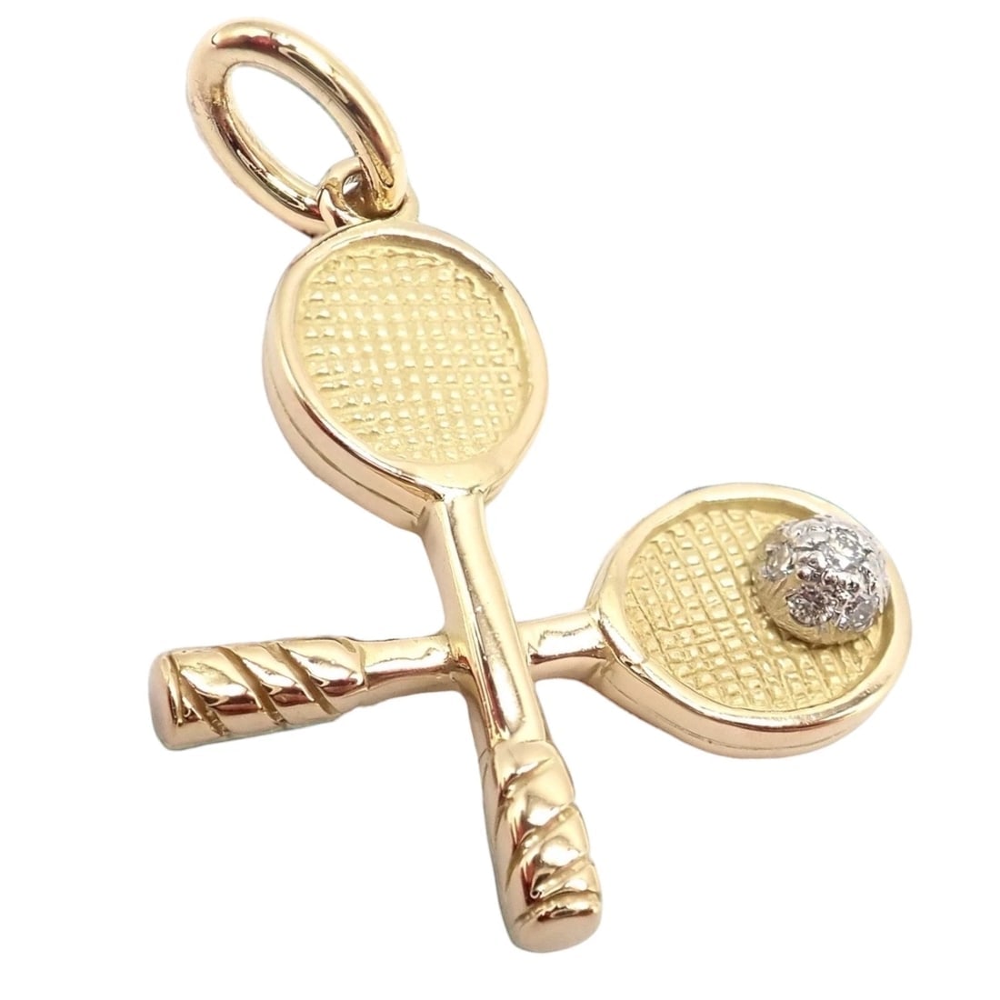 Rare Vintage Tiffany & Co. 18k Yellow + White Gold Tennis Rackets Diamond Charm: A rare vintage Tiffany & Co. charm depicting crossed tennis rackets in rich 18k yellow gold, highlighted by an 18k white gold tennis ball set with a sparkling diamond. Meticulously crafted, this colle