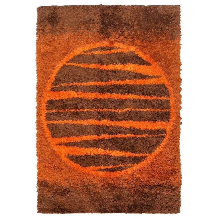 Supernova Shag Rug with Abstract Design, circa 1970: Swedish shag wool area rug with an abstract Supernova design resembling a sun featuring various shades of browns and burnt orange. An excellent colorful rug to accent your room with a color-infused