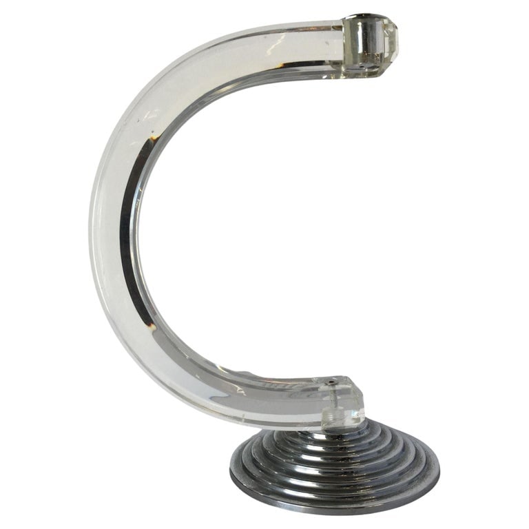 Art Deco Inspired Lucite and Chrome Candlestick Holder: Art Deco inspired candlestick holder with a shaped piece of Lucite fixed to stepped Art Deco base. Reserve: $190.00 Shipping: Domestic: Shipping rates are determined by destination International: