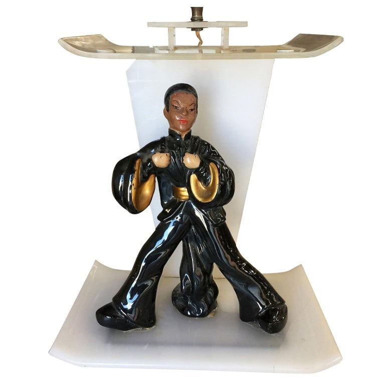 Midcentury Asian Inspired Lucite Sculptural Lamp by Moss: Midcentury Asian inspired Lucite lamp by Moss featuring a handcrafted acrylic lamp with decorative ceramic China man statue in the middle. Reserve: $828.00 Shipping: Domestic: Shipping rates are