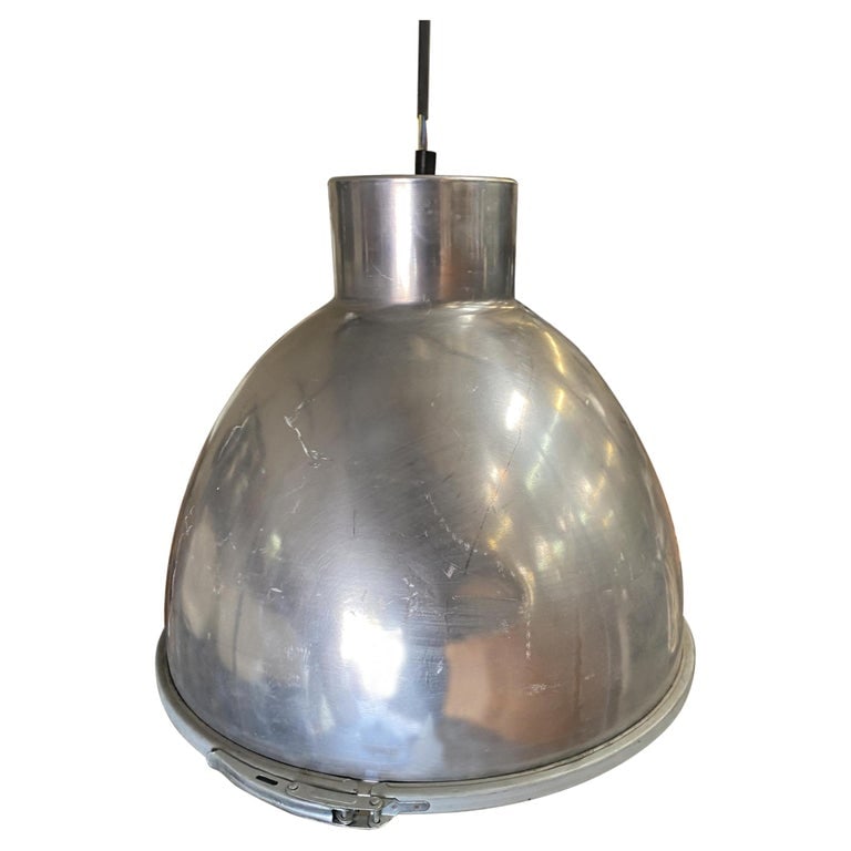 Large Aluminum Industrial Pendant Light Fixture: Large 16" wide industrial pendant light fixture featuring an aluminum housing with a quick release safety glass shade. Fixture takes a standard 120w socket, Circa 1970 Available-4. Reserve: $1,242.00