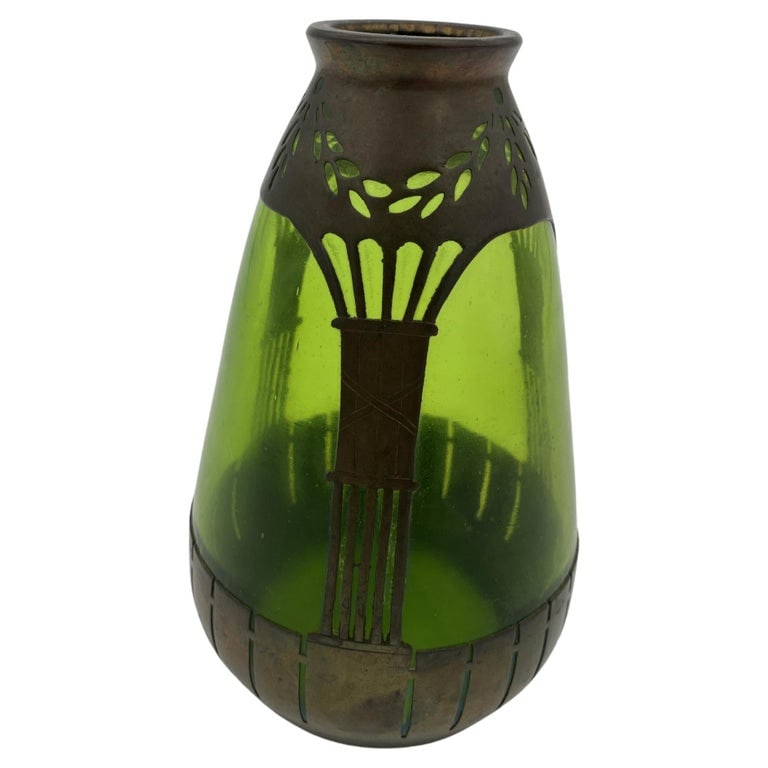 French Art Nouveau Copper and Green Glass Vase: French Art Nouveau copper and green glass vase featuring a hand-blown green with a copper frame. Circa 1900. Reserve: $510.00 Shipping: Domestic: Shipping rates are determined by destination Internati