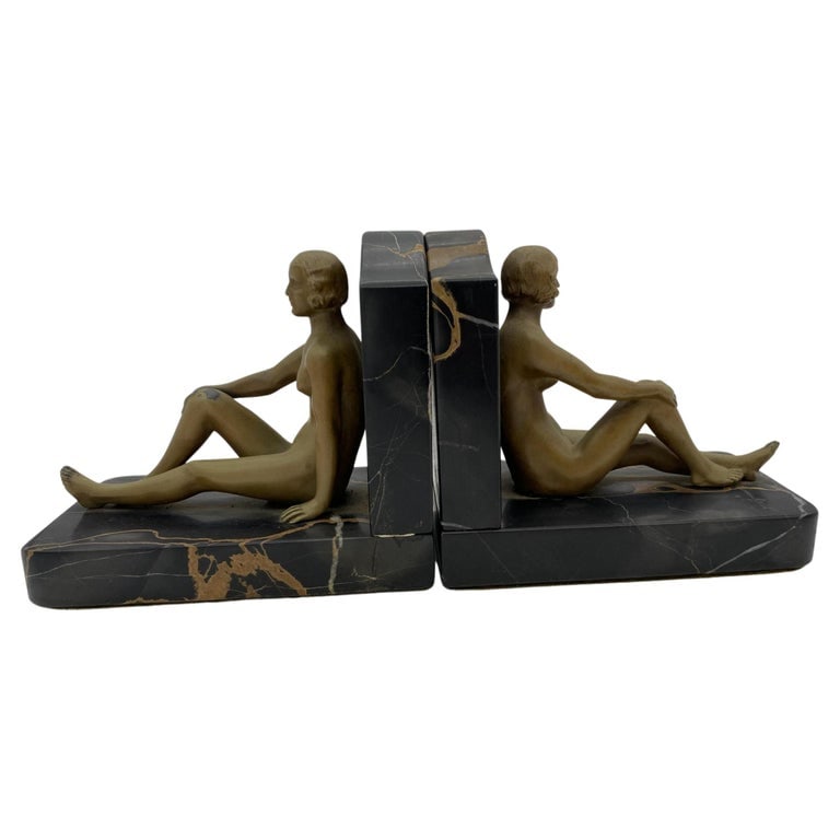 French Nude Flapper Girl Spelter Metal & Marble Bookend Pair, 1920: Hand-casted nude Art Deco flapper girl cast in spelter metal statue with enamel finish fixed to marble stands. In the style of Frank Art, The Flapper girls captures the essence of the liberated,