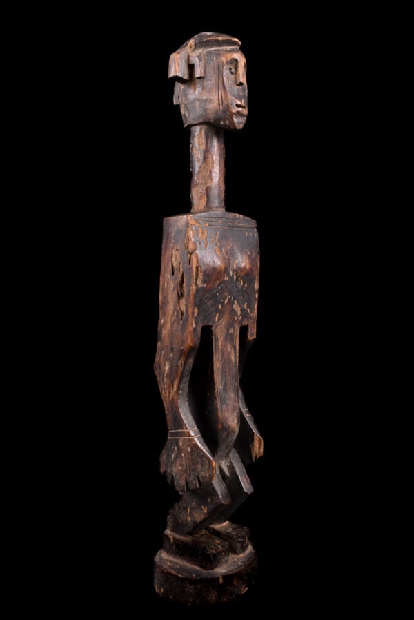 Ancestor Figure - Wood - Bambara - Mali: Stylistic wooden ancestor statue of the Bambara tribe from Mali. The Dyonyeni are associated with the southern Dyo and Kwore society. These female statues usually appear with large conical breasts and