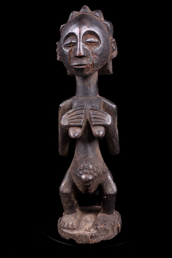 Ancestor figure - Wood - Luba - DR Congo: Stylistic wooden male ancestor figure from the Luba people of DR Congo. The figure has a fine face expression. This serene Luba figure epitomizes the art and mystery that carvers from this tribe have