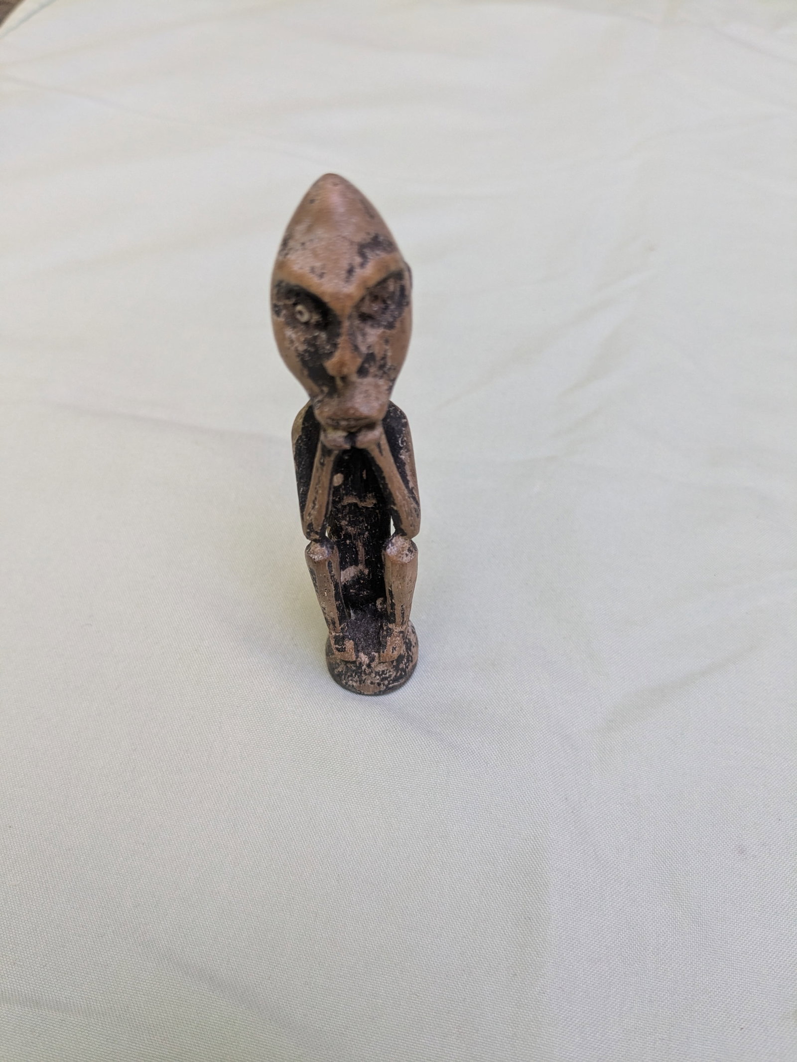 Small Squating Spirit Figure: Title: Small Squating Spirit Figure Description: This 'Hampatong" carving is from the Dayak people of Borneo, Indonesia. These small figures carved from durable ironwood, are designed to provide