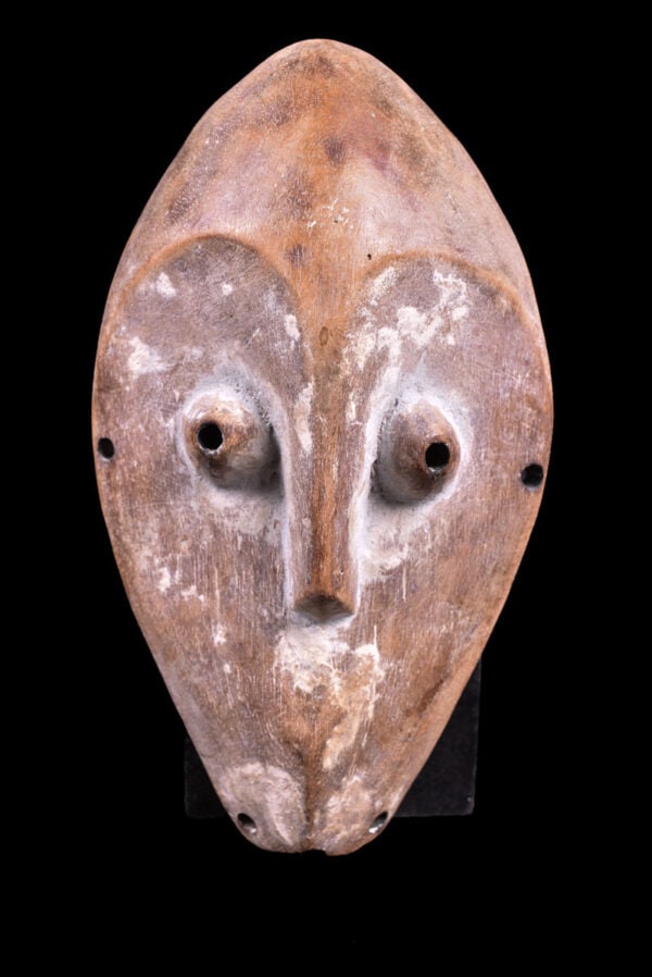 Mask - Wood - Lega - Congo: Lovely Lega Mask from Zaire or Congo. Wood with multi-layered patina. Remains of offerings, mica powder, kaolin. Condition: good with a beautiful aged patina due to tribal use. Covered in Pembe, white