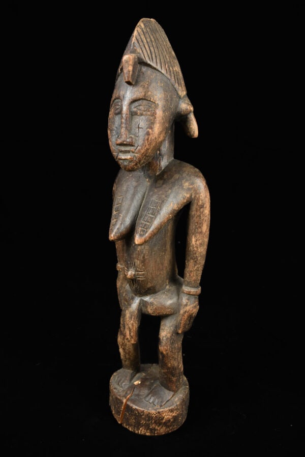 Ancestor Figure - Wood - Senufo - Ivory Coast: Stylistic standing wooden ancestor figure from the Senufo tribe of Ivory Coast. The Senufo (the francophone spelling Senoufo is commonly used) are an ethnolinguistic group composed of diverse subgroup