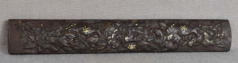 18c Japanese sword KOZUKA shishi & peonies: 18th century Japanese iron kozuka (sword knife) handle with low relief decoration of several shishi (Buddhist lions) frolicking among blooming peonies. Difficult to photograph, good quality work with