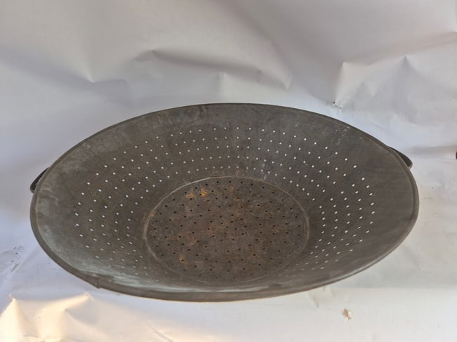 Early sheet tin colander: Probably made for a large home as 19 1/2" diameter. Excellent condition, Pennsylvania, c.1880. Shipping: Domestic: Shipping rates are determined by destination International: Foreign shipping rates
