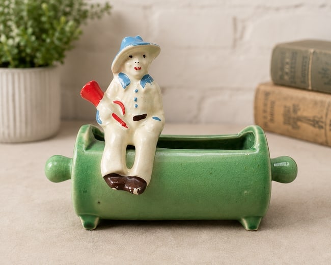 Vintage 1952 McCoy Rolling Pin Planter with Seated Farmer Figure Green Pottery: Date/Period: 1952 Dimension: Measures approximately: 5.25" tall 7" long (plus approximately 2.5" handle extensions) Weighs approximately 14 oz Material: ceramic Additional Information: Charming and