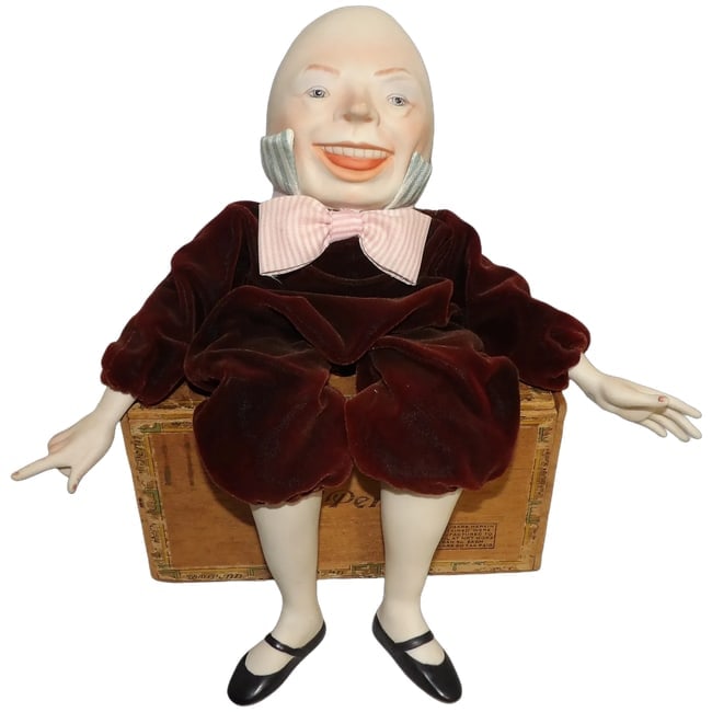 Humpty Dumpty Doll by Faith Wick for Silvestri: This Humpty Dumpty doll by Faith Wick for Silvestri has a porcelain head, hands and legs. Dressed in maroon velvet with cloth bow tie and collar. It is in excellent condition. It has the W for Wicket 