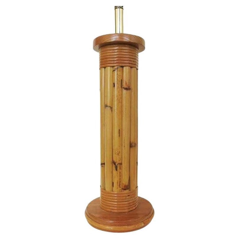 Restored Wrapped Rattan Pole Lamp with Mahogany Base: Wrapped rattan pole lamp with a round mahogany base cap. The center was been hand wrapped with wicker bands. 1950, United States We only purchase and sell the best and finest rattan furniture made by