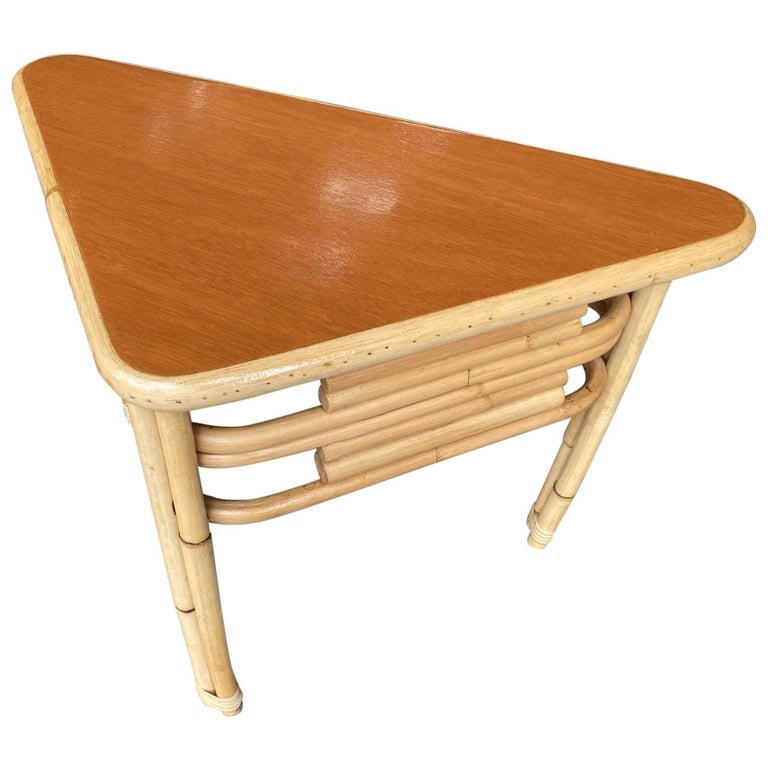 Restored Stacked Rattan Corner Side Table with Mahogany Tabletop: Stacked rattan corner table with a laminate mahogany style tabletop. 1950, United States We only purchase and sell the best and finest rattan furniture made by the best and most well-known American