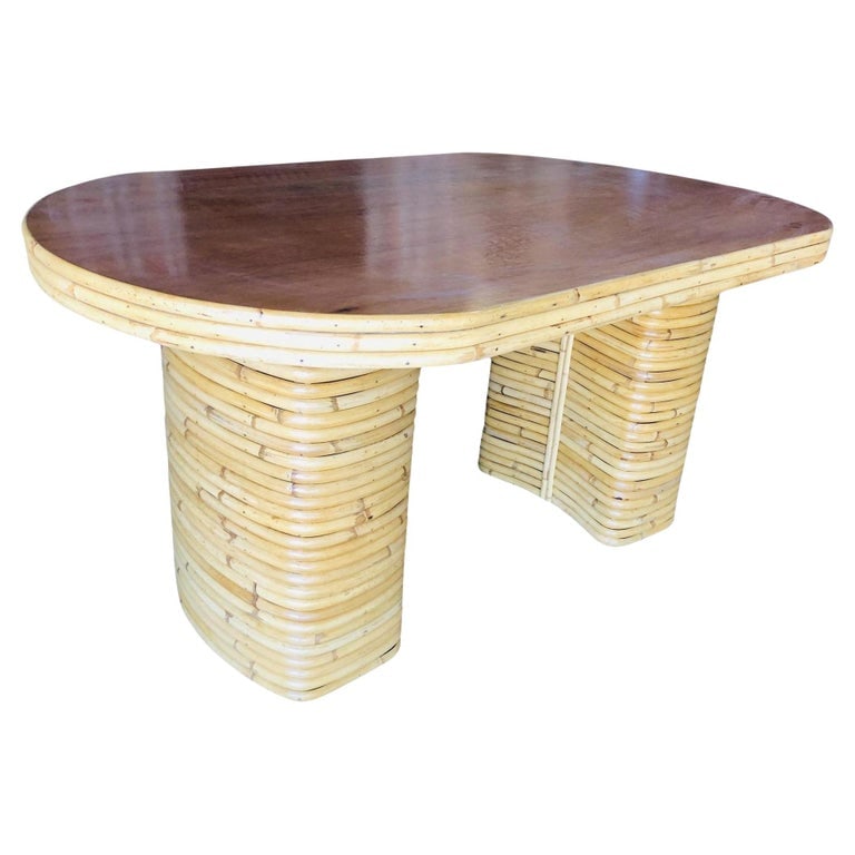 Restored Oval Stacked Rattan Dining Table W/ Mahogany Top: Mid-century six-person rattan dining table with stacked rattan base legs, 3-strand rattan trim, and an oval mahogany table. 1950, United States We only purchase and sell only the best and finest ratta