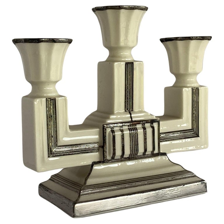 Stepped Art Deco Candelabra with Sterling Silver Overlay by Lenox: Stepped Art Deco ceramic candelabra with sterling silver overlay by Lenox. Circa 1930. Reserve: $750.00 Shipping: Domestic: Shipping rates are determined by destination International: Foreign shipping