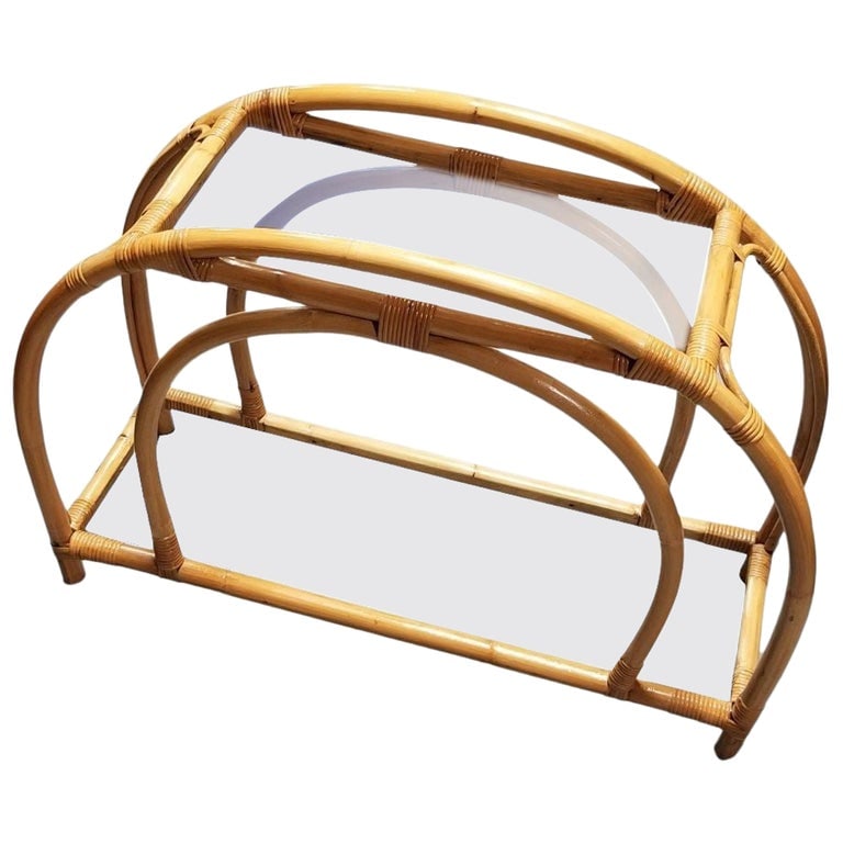 Restored Rattan Double Arched Two-Tiered Single Strand Table: This beautifully restored Paul Frankl-inspired Mid-Century rattan double arched two-tiered glass shelf side table. Circa 1950, USA. We only purchase and sell only the best and finest rattan furniture