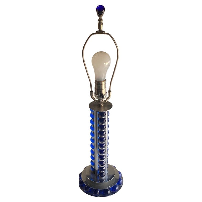 Chromed Steel and Cobalt Marble Art Deco Lamp: Crafted around 1930, the chromed steel and cobalt marble machine age art deco lamp is a striking blend of sleek design and industrial allure. With its chromed steel structure, cobalt marble accents,