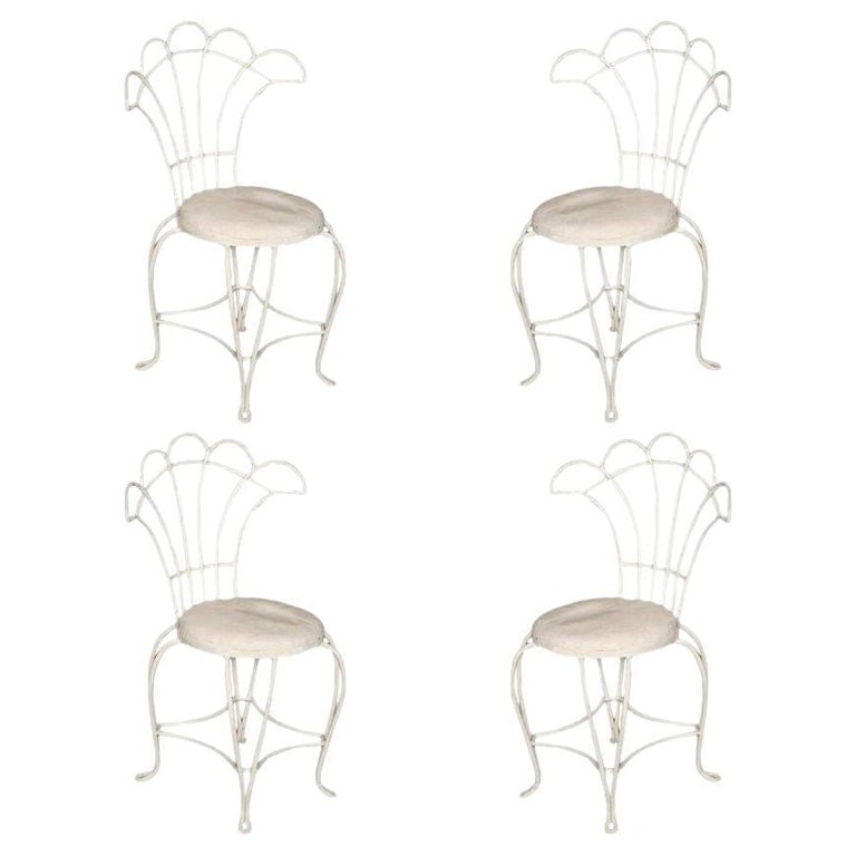Mathieu Mategot Inspired French Wrought Iron Fan Back Patio Chairs, Set of Four: Reminiscent of a Paris cafe, a set of four French wrought iron outdoor/patio chairs with distinct floral inspired fan backrest. This chair is constructed with solid core wrought iron professionally re