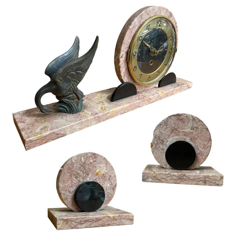 French Art Deco UCRA Bronze Swan Marble Mantle Garniture Clock Set by Marefbay: A Three Piece Marefbay Art Deco Marble and Bronze Clock Garniture, circa 1930 Marks: MAREFBAY 9 x 13-1/4 x 3 inches (22.9 x 33.7 x 7.6 cm) (clock) The circular Arabic numeral clock on a rectangular ma