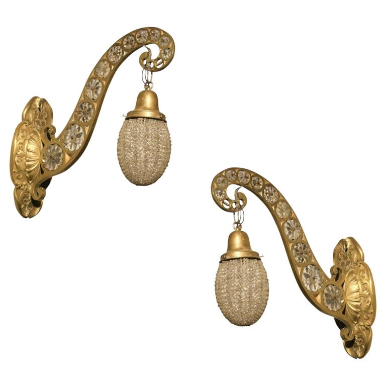 Hollywood Regency Brass and Crystal Beaded Sconce, Pair: This unique pair of Hollywood Regency sconces is rendered in cast brass and embellished with crystal beading throughout. Sold as a set of 2 Circa 1930 USA Reserve: $2,760.00 Shipping: Domestic: Shippi