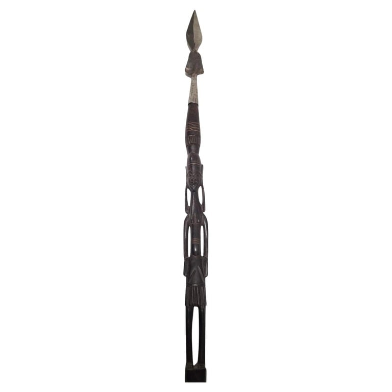 Makonde Tanzanian Carved Warrior Female Spear: Warrior woman hunting spear of the African Makonde tribe. Traditionally, Makonde wood carving has served as a means of storytelling, preserving their history and traditions through the intricate