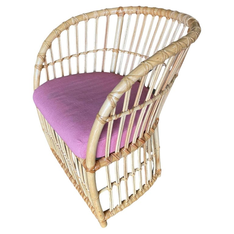 Restored 1970s Pencil Reed Rattan Armchair: Pencil Reed Rattan spindle barrel armchairs, each chair features a padded seat. 1970, Italy We only purchase and sell the best and finest rattan furniture made by the best and most well-known